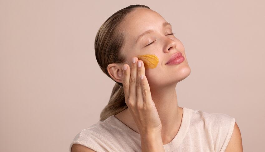 A woman applying skin care