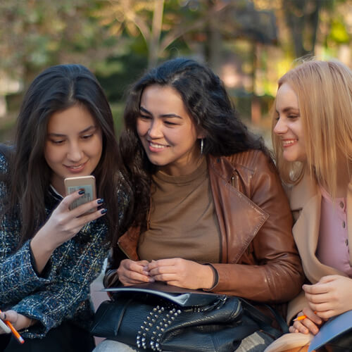 Women smiling and look at a phone